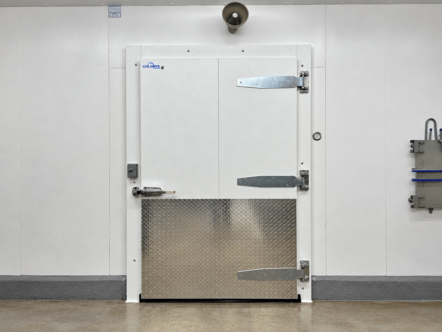 White Coldrite walk-in cooler door with diamond-plate kick plate